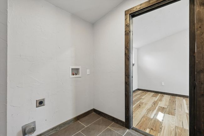 Laundry room with dark wood-type flooring, baseboards, laundry area, hookup for a washing machine, and hookup for an electric dryer | Image 28