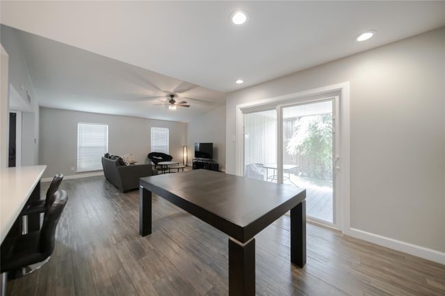 Dining room featuring wood finished floors, a ceiling fan, and recessed lighting | Image 9