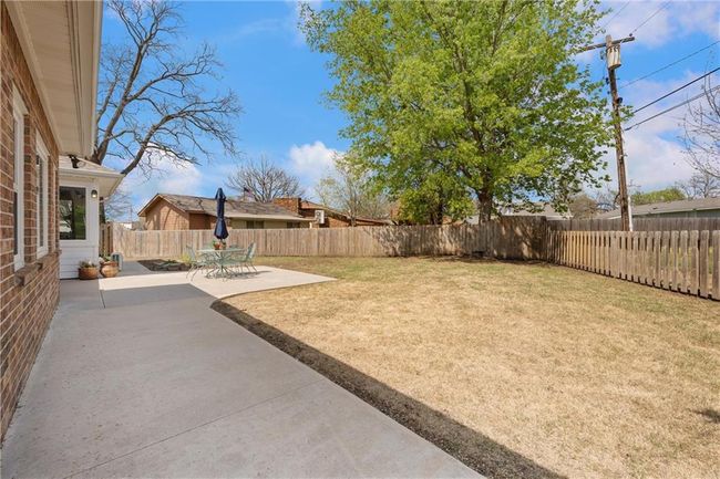 View of yard featuring a patio area and a fenced backyard | Image 44