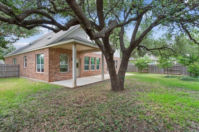 Fenced backyard featuring a patio area | Image 37