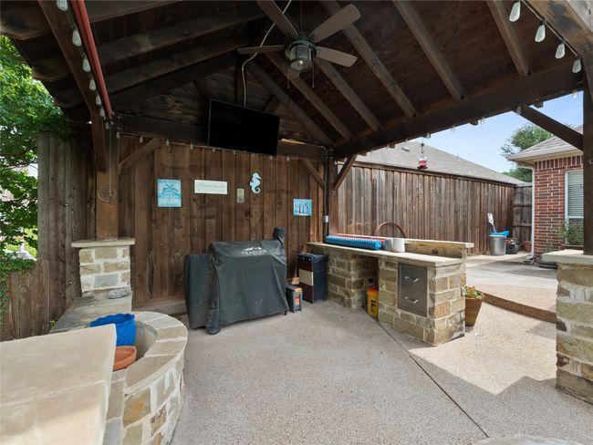 View of patio featuring ceiling fan and grilling area | Image 24