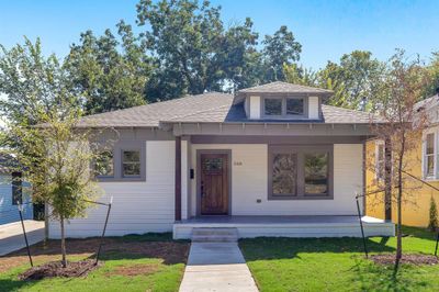 View of front of home featuring a front yard and covered porch | Image 1