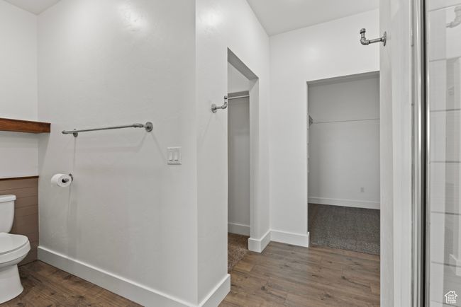 Bathroom featuring toilet, wood finished floors, and baseboards | Image 18