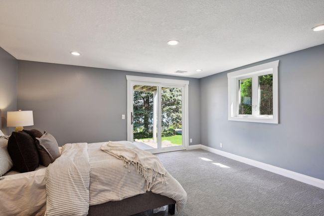 Lower-level bedroom is extra large and walks out to the patio. | Image 25
