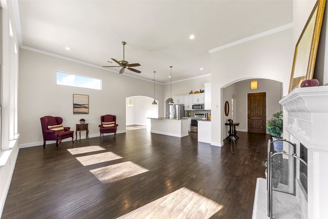 A wholistic view of the open living area showing dining room in background and boasting those beautiful vinyl floors. | Image 10