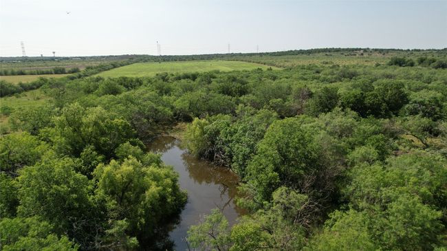 1st stock tank located centrally in tree grove. | Image 6