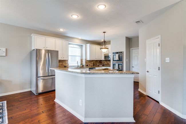 The breakfast bar is the perfect place to set up a buffet or charcuterie board. | Image 12