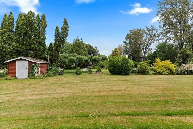 View of green lawn with a storage shed | Image 33