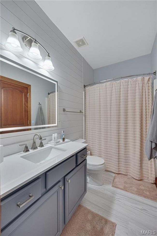 Full bathroom with vanity and wood walls | Image 33