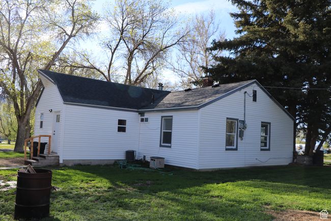View of property exterior with a lawn and roof with shingles | Image 41