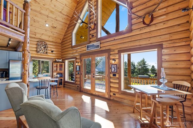 Living room looking towards the kitchen and dining areas. | Image 12