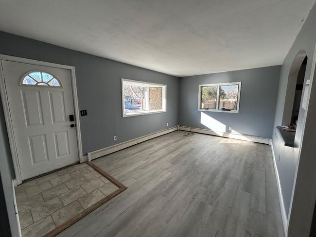 Foyer with a baseboard heating unit and light hardwood / wood-style floors | Image 6