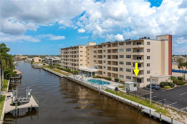 View of building exterior with a community pool and a water view | Image 34