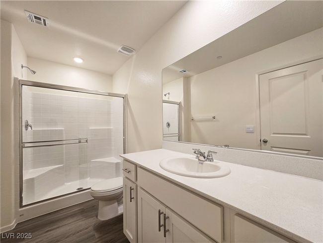 Bathroom featuring wood finished floors, toilet, vanity, and a shower stall | Image 32