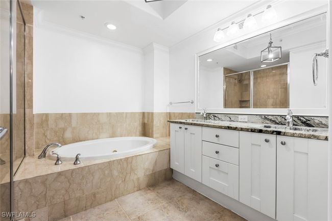 Bathroom featuring vanity, independent shower and bath, ornamental molding, and tile patterned floors | Image 40