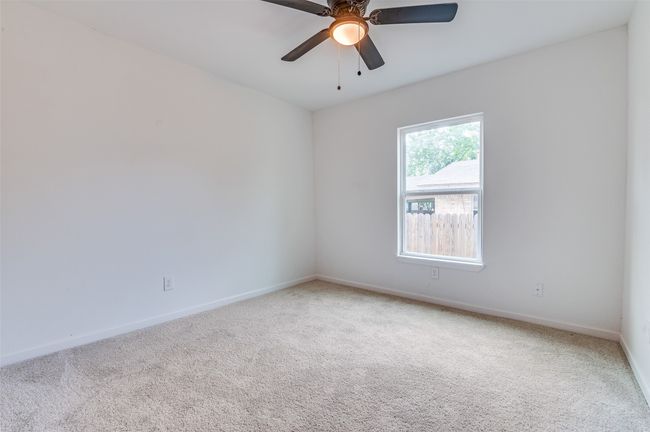 Unfurnished room featuring carpet floors, baseboards, and ceiling fan | Image 21