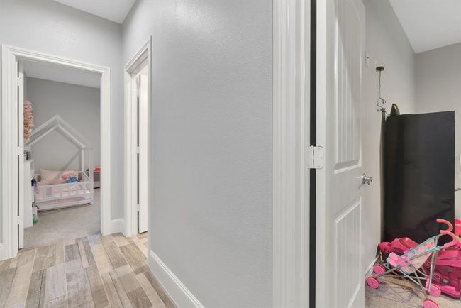 A thoughtfully designed hallway leads to three Bedrooms. | Image 31