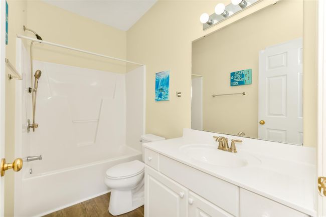 Full bathroom featuring vanity, toilet, bathtub / shower combination, and wood finished floors | Image 15