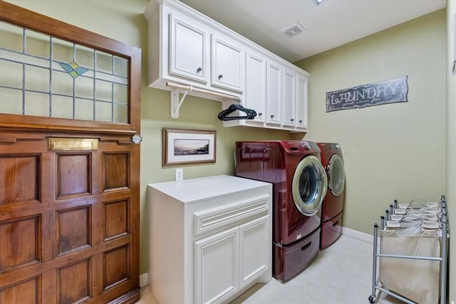 Laundry room off the kitchen and garage, enclosed by this gorgeous antique door | Image 14