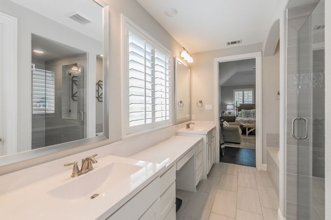 Ensuite bathroom featuring double vanity, a shower stall, and tile patterned flooring | Image 20