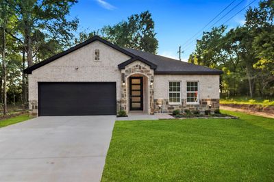 View of front of home with a garage and a front lawn | Image 1