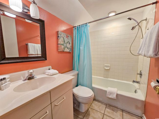 Full bathroom featuring tile patterned floors, vanity, shower / bath combination with curtain, and toilet | Image 29