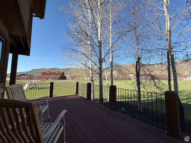 Deck with a yard and a mountain view | Image 83