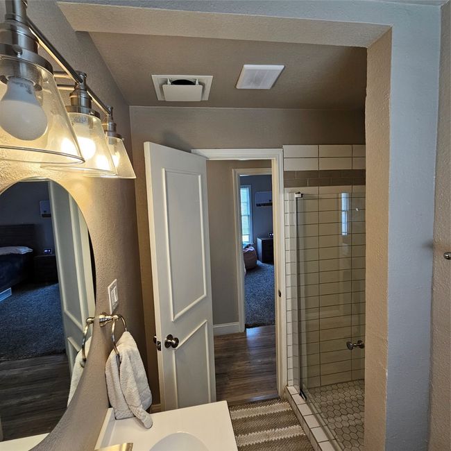 Bathroom featuring a stall shower, wood finished floors, and ensuite bathroom | Image 22