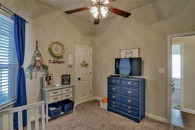 Carpeted bedroom featuring ceiling fan and baseboards | Image 25