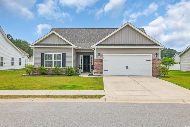 Craftsman inspired home with a front lawn, brick siding, and vinyl siding. | Image 5