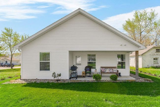 Rear view of property featuring a porch and a yard | Image 28
