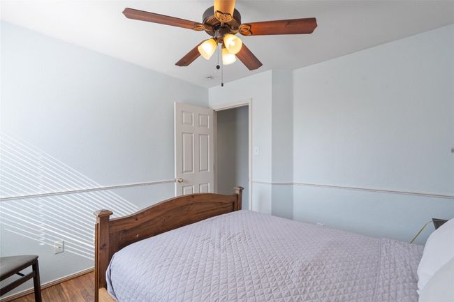 Bedroom with ceiling fan and wood finished floors | Image 22