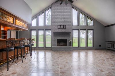 Living room with bar, looking out onto golf course | Image 1