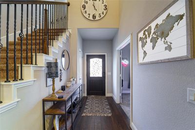 Entryway with a towering ceiling and wood-type flooring | Image 2