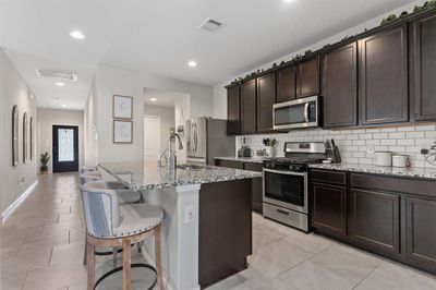 Wonderful Open Floor Plan! Gourmet Kitchen is a Chef's dream and no worries cooking those fabulous meals and missing out on time with the family while doing so! Huge Working and Eat In Island and a wonderful place to call Home! | Image 1