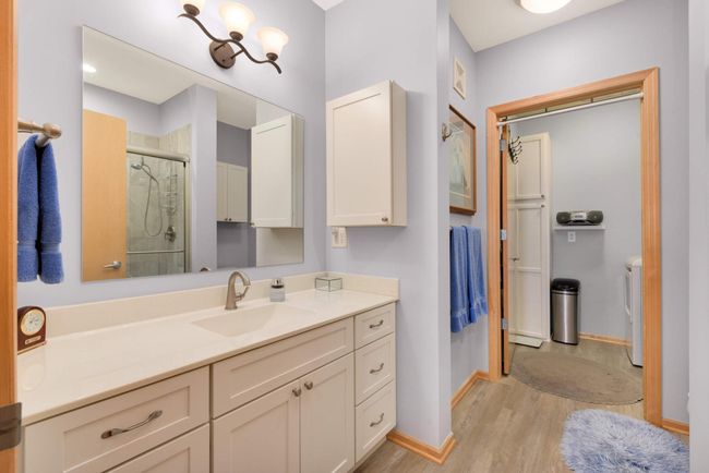 A view of the spacious bathroom into the laundry room. | Image 15
