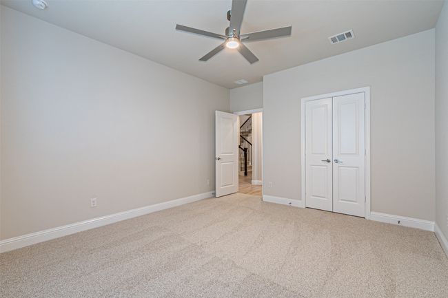 Unfurnished bedroom featuring light colored carpet, a closet, and ceiling fan | Image 7