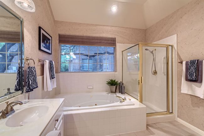 Separate shower and jetted tub, medicine cabinet and cabinets above the commode for extra storage. | Image 20
