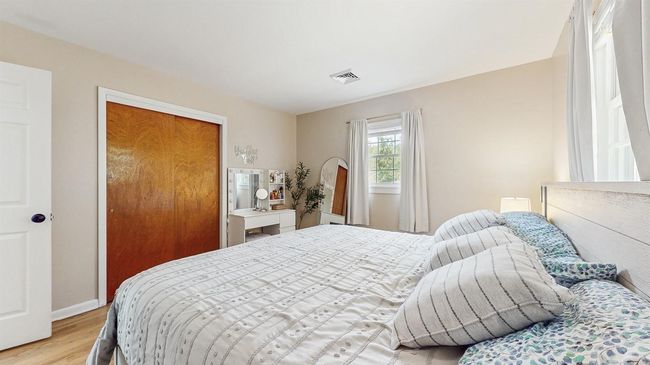 Huge Bedroom with light stained hardwood-style flooring and large closet | Image 17