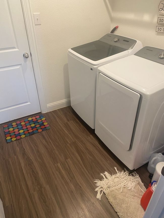 Washroom featuring washer and clothes dryer and dark wood-style floors | Image 27