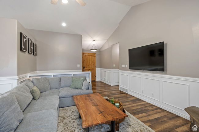 Living room with ceiling fan, dark hardwood / wood-style floors, and vaulted ceiling | Image 8