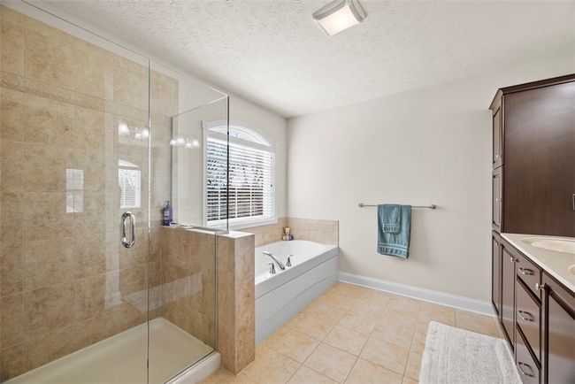 Start or end your day in the jet tub or the tiled in shower. Tile flooring flows throughout the bathroom. | Image 28
