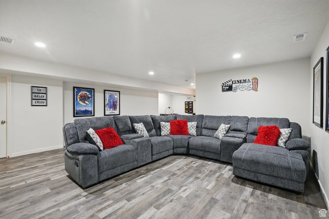 Living room with light wood-style floors, recessed lighting, visible vents, and baseboards | Image 37