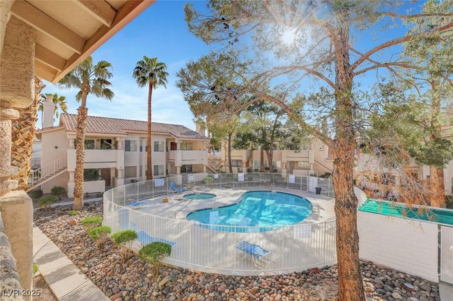 Community pool with fence and a community hot tub | Image 28