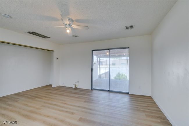 Spare room featuring ceiling fan, light wood-style floors, a textured ceiling, and a smoke detector | Image 38