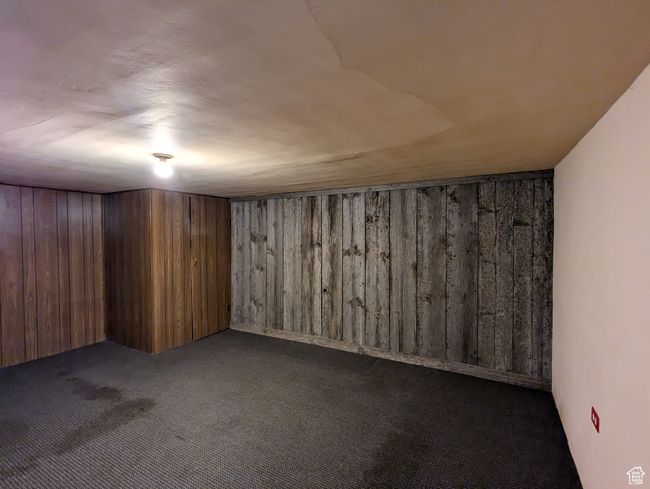 Finished basement with wooden walls and carpet floors | Image 15