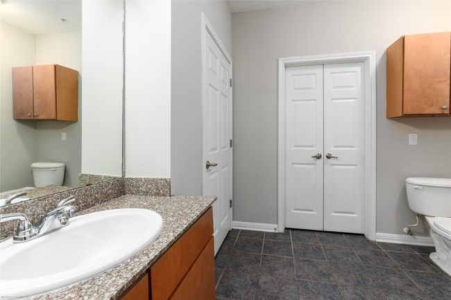 Bathroom featuring a closet, vanity, and tile patterned flooring | Image 18
