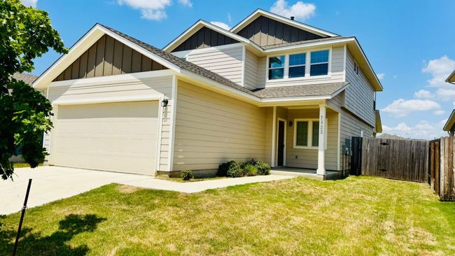 View of front of house featuring board and batten siding, an attached garage, a gate, concrete driveway, and roof with shingles | Image 5