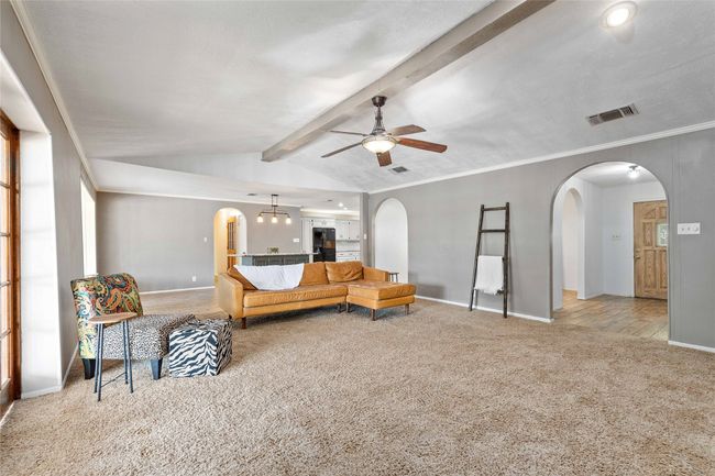 Living room with vaulted ceilings and wood burning fireplace | Image 9