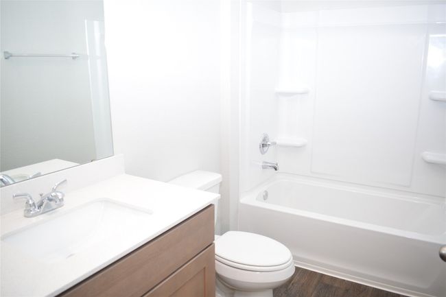 Full bath with shower / bathtub combination, vanity, and dark wood-type flooring | Image 18